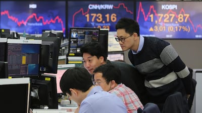Traders watch monitors at KEB Hana Bank headquarters in Seoul, South Korea. Equity markets have attempted to rally as policymakers rolled out the textbook responses seen during past global crises. Associated Press