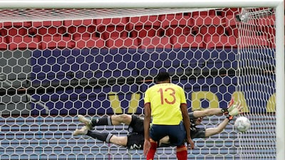 Argentina goalkeeper Emiliano Martinez saves a penalty shot by Colombia's Yerry Mina.
