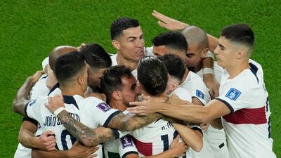Portugal players mob Ricardo Horta after his early goal. AP