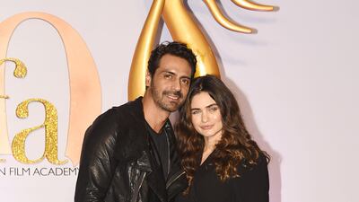 Bollywood actor Arjun Rampal and girlfriend Gabriella Demetriades arrive for the IIFA Rocks of the 20th International Indian Film Academy (IIFA) Awards at NSCI Dome in Mumbai on September 16, 2019
