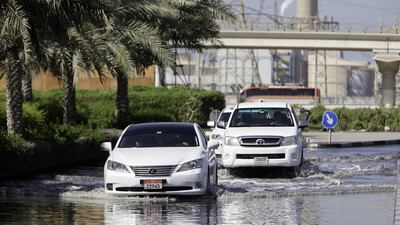 Cars passing through a waterlogged road near Ibn Battuta Mall as residents near the mall tackle new floods in the area. Jaime Puebla / The National