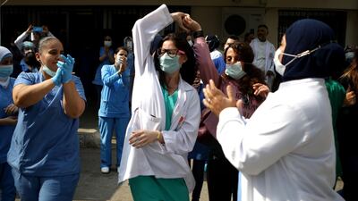 Staff of a Lebanese government hospital dance to music played by a band thanking them for their efforts. AFP