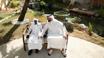 Yousif Lootah, executive director of SS Lootah Group and chairman of Lootah Biofuels, interacts with his humanoid robot, Bu Sunaidah, at his home in Dubai. Reuters