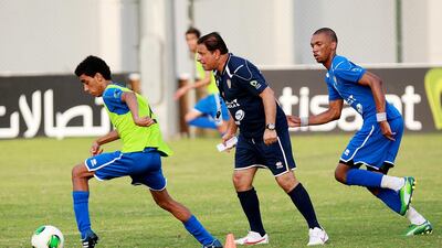 Abdullah Al Shahin, centre, assistant coach of the UAE U17 team, gets in the middle of things during a training session at the UAEFA pitch in Dubai. The team is leaving Friday for a training camp in Spain. Satish Kumar / The National