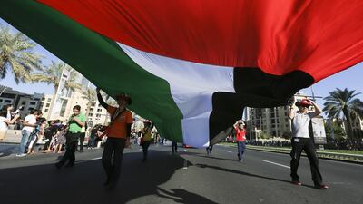 A parade celebrating the UAE’s National Day passes through the streets of Downtown Dubai. Sarah Dea / The National