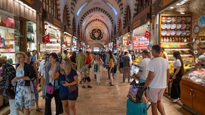 Tourists inside the Grand Bazaar in Istanbul, Turkey. Despite a strong rebound in the country's tourism industry, Fitch estimates that higher energy prices and weaker external demand will result in a current account deficit of 5.1% of gross domestic product in 2022. Photo: Bloomberg
