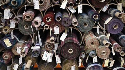 Finished rolls of fabric await dispatch to famous brands such as Ralph Lauren, Dolce & Gabbana, Burberry and Paul Smith. Oli Scarff / AFP