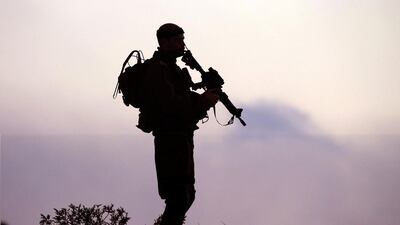 An Israeli soldier keeps his position near Israel's border with the Gaza Strip on July 29, 2014. The Israeli offensive, which began on July 8 to end Hamas rocket attacks on the Jewish state, has killed nearly 1,200 Palestinians, dealing a blow to Israel's public relations campaign. Jack Guez/AFP Photo