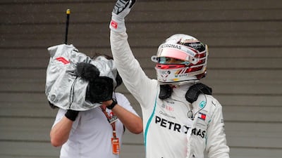 Lewis Hamilton celebrates pole position for the Japanese Grand Prix after qualifying. Reuters