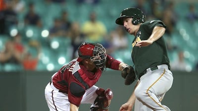Australia Baseball's Mitch Dening tries to slide around a tag at the plate by Arizona Diamondbacks catcher Miguel Montero during an exhibition between the Diamondbacks and Team Australia at Sydney Cricket Ground on Friday. Rick Rycroft / AP / March 21, 2014