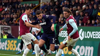 West Ham United's Aaron Cresswell, centre, and Burnley's Jeff Hendrick, right, battle for the ball on Saturday. PA