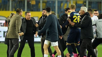 Referee Halil Umut Meler on the ground after being punched by Ankaragucu president Faruk Koca, second left. AP