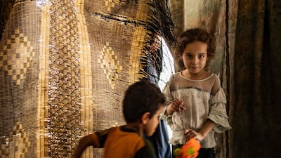 Syrian children, displaced with their family from Deir Ezzor, play in a damaged building where they now live in Syria's northern city of Raqqa.