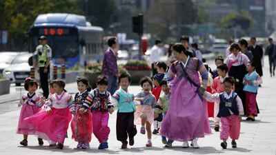 Children wearing South Korea’s traditional costume “Hanbok” walk together hand in hand during a street campaign to encourage people to wear “Hanbok” for the upcoming country’s holiday, Chuseok, the Korean version of Thanksgiving Day, which falls on September 27, in Seoul, South Korea. South Koreans will visit their hometowns during the four-day holiday starting on Saturday. Lee Jin-man / AP