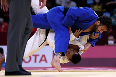 Zhanbota Amanzhol of Kazakhstan, in white, and Helios Latchoumanaya of France compete in the men's -90kg judo at the Tokyo Paralympic Games in 2021. Getty