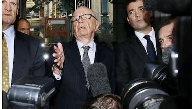 Rupert Murdoch, centre, attempts to speak to the media after he held a meeting with the parents and sister of murdered school girl Milly Dowler in London, Friday, July 15, 2011. Murdoch's loyal lieutenant Rebekah Brooks resigned Friday as chief executive of his embattled British newspapers, becoming the highest-ranking casualty yet in the phone-hacking scandal roiling Britain.