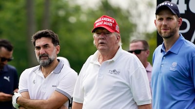 Yasir Al Rumayyan, left, governor of Saudi Arabia's Public Investment Fund, which is financing the LIV Golf series, stands alongside Mr Trump and his son, Eric. AP