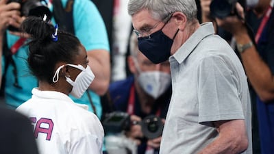 IOC President Thomas Bach (right) speaks to USA's Simone Biles at Ariake Gymnastic Centre.