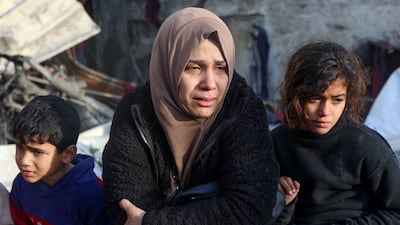A woman cries in the aftermath of an Israeli strike at Al Farabi school in the centre of Gaza city, which is sheltering a number of displaced people. AFP