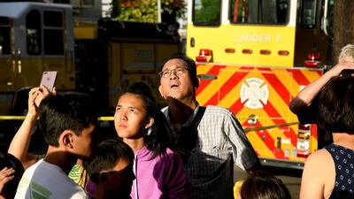 Evacuated residents look up at Marco Polo apartment building after a fire broke out in it in Honolulu, Hawaii. Hugh Gentry / Reuters