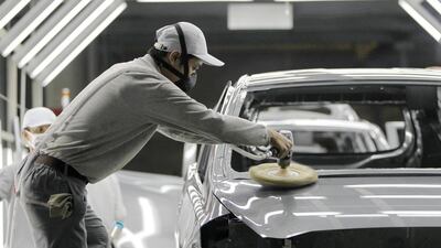 A worker polishes a body of Datsun Go+ at an assembly line in the Nissan Indonesia factory. Beawiharta / Reuters