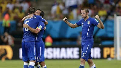 italy players Thiago Motta, left, Andrea Pirlo, centre, and Giorgio Chiellini, right, celebrate after beating England 2-1 at the 2014 World Cup on Saturday night in Manaus, Brazil. Marcio Jose Sanchez / AP