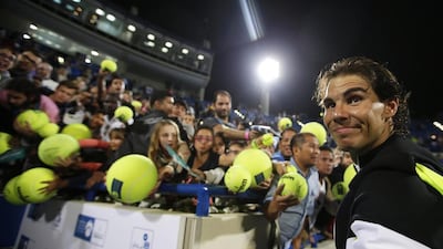 Rafael Nadal signs autographs after defeating Milos Raonic of Canada in the final. Ali Haider / EPA