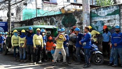 Construction workers evacuate their building in Manila after the quake. AFP