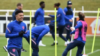 England's Jadon Sancho smiles during training. PA