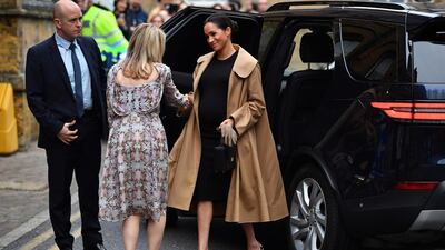 Meghan, Duchess of Sussex wears an Oscar de la Renta coat, Hatch dress and Gianvito Rossi heels visit the Smart Works charity in Londo on January 10, 2019. / AFP / Ben STANSALL