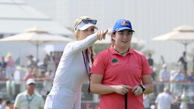 Saoirse Lambe of Ireland, who won a global competition to play with Rory McIlroy and Niall Horan, is assited by Paige Spiranac during the pro-am at Emirates Golf Club. David Cannon / Getty Images