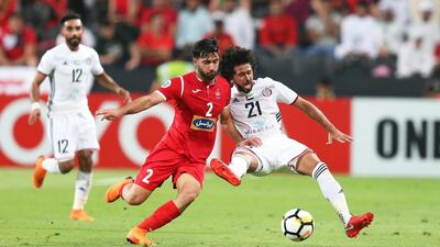 Al Jazira's Yaqoub Al Hosani, right, in action against Sadegh Moharrami of Persepolis during their Asian Champions League game at Mohammed bin Zayed Stadium in Abu Dhabi. Ali Haider / EPA