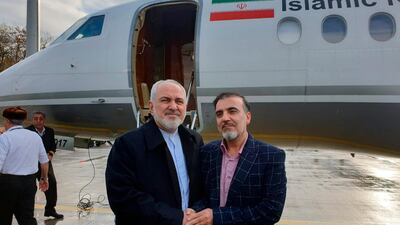 Iran's Foreign Minister Mohammad Javad Zarif, left, shakes hand with Iranian scientist Massoud Soleimani prior to leaving Zurich, Switzerland for Tehran, Iran. AP