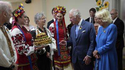Britain's Prince Charles and Camilla, Duchess of Cornwall, are presented with bread and salt during a visit to a Ukrainian church in Ottawa on their Canadian Royal Tour, May 18, 2022. AFP