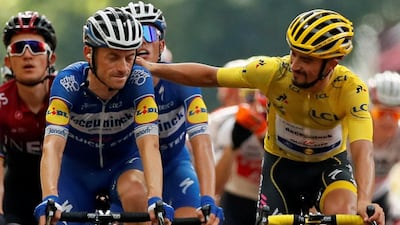 Julian Alaphilippe in the yellow jersey alongside defending Tour de France champion Geraint Thomas at the end of Stage 17. Reuters