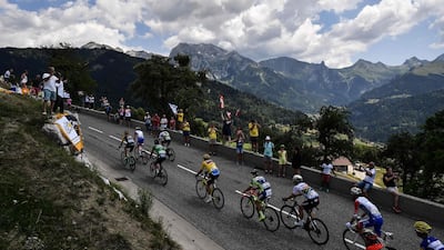 Belgium's Greg van Avermaet, centre, wearing the overall leader's yellow jersey, rides in a breakaway group during the 10th stage of the Tour de France between Annecy and Le Grand-Bornand. Jeff Pachoud / AFP