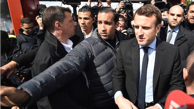 Emmanuel Macron, flanked by his bodyguard, Alexandre Benalla (L), arrives outside the Whirlpool home appliance factory, in Amiens, northern France on April 26, 2017. AP