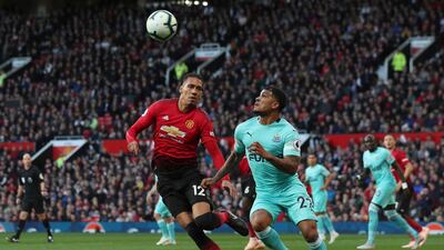 Manchester United's Chris Smalling, left, vies for the ball with Newcastle United's DeAndre Yedlin. AP Photo