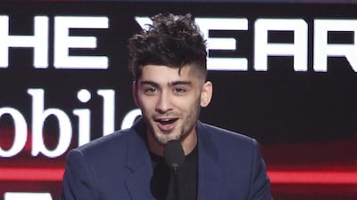 Zayn Malik accepts the award for new artist of the year at the American Music Awards in Los Angeles. Matt Sayles / Invision / AP