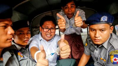 Myanmarese journalists Wa Lone (C) and Kyaw Soe Oo leaving court in Yangon. EPA