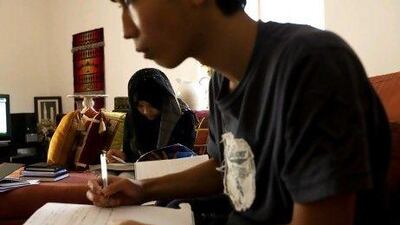 Hazwan, 16, right, and Syazwina Hamdan, 14, who are home schooled by their mother, study at their Mirdif area home.