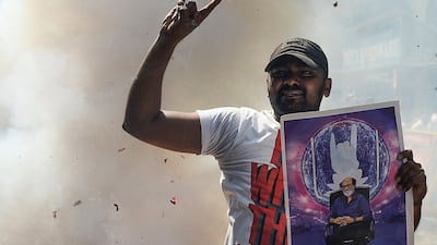 An Indian fan of Rajinikanth celebrates after his announcement. Arun Sankar / AFP