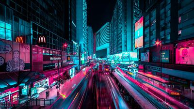 In 'Urban Artery', tramway, bus, cars and people are going through Causeway Bay like ghosts. Causeway Bay, Hong Kong. Photographer: Xavier Portela