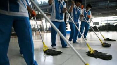 Thai workers clean the floor at Suvarnabhumi International Airport after the end of the seige.