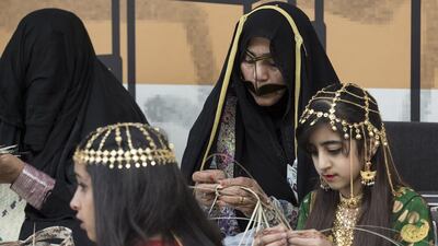 Women and girls weave handicrafts during a barza at Qasr Al Hosn. Ryan Carter / Crown Prince Court - Abu Dhabi