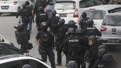 Police officers are deployed near the site. Dita Alangkara / AP Photo