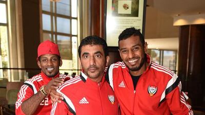 Defender Mohammed Ahmed, right, sports a big grin alongside a member of the back-rom staff as Mohammed Yousef, left, creeps into the photo.
