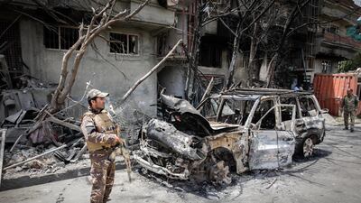 An Afghan security officer inspects the scene of the damaged area a day after a suicide attack followed by a gunfight against the office of Afghan former chief of intelligence and current candidate for first vice president of Ashraf Ghani, in Kabul. EPA