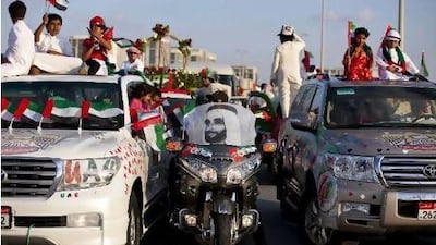 People show off their decorated cars during the Spirit of Union Parade at Yas Island.