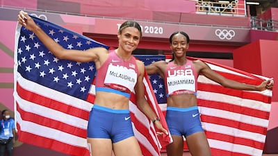 First-placed USA's Sydney Mclaughlin and second-placed USA's Dalilah Muhammad celebrate after competing in the women's 400m hurdles final.